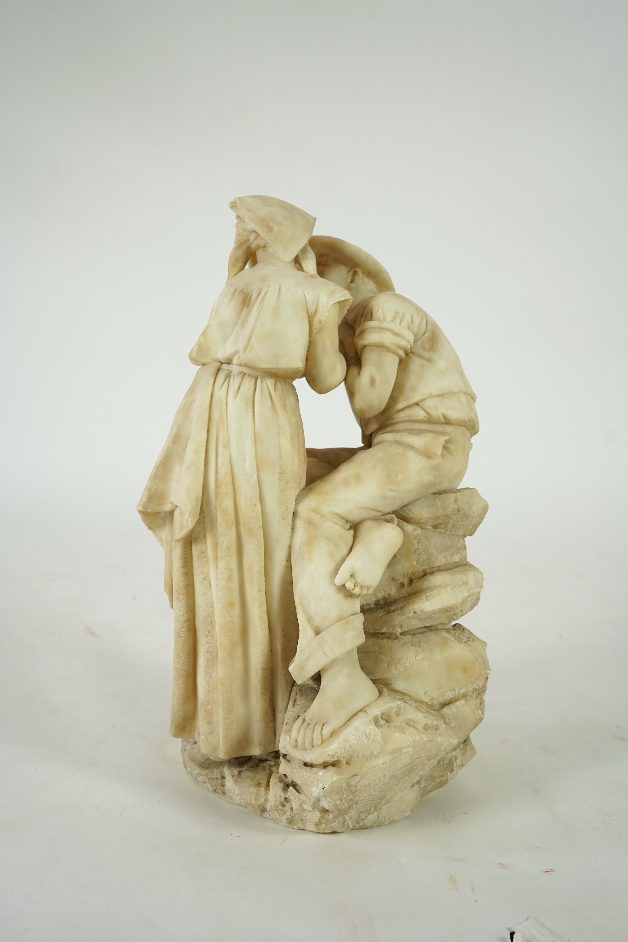 A large Continental alabaster group of a peasant couple, late 19th / early 20th century